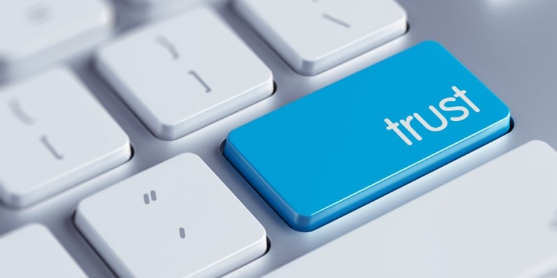 Keyboard buttons and one reads the word 'trust'.